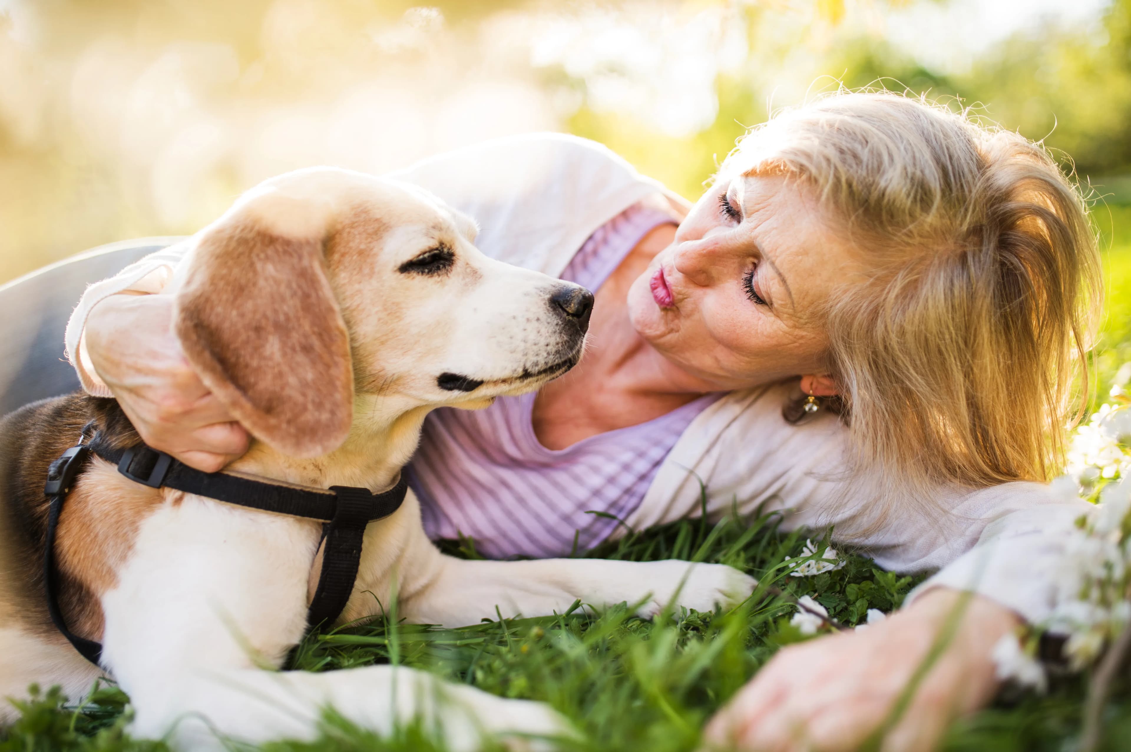 Woman sharing a close outdoor moment with her dog