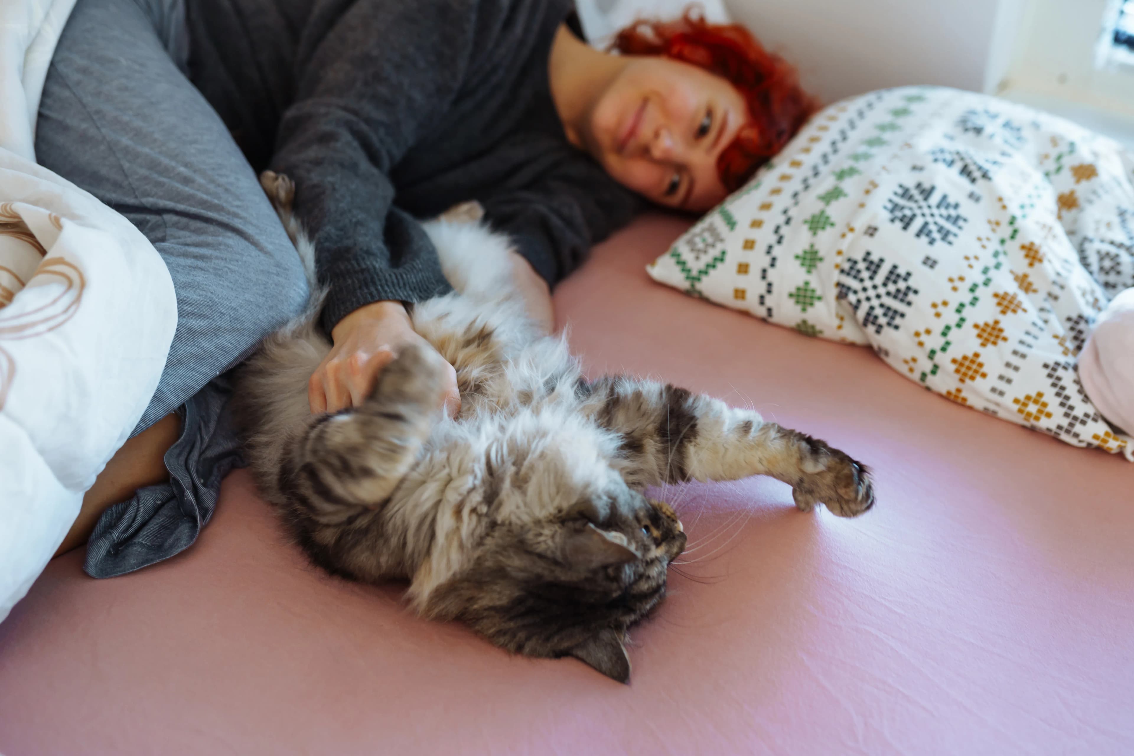 A woman relaxing at home with her cat