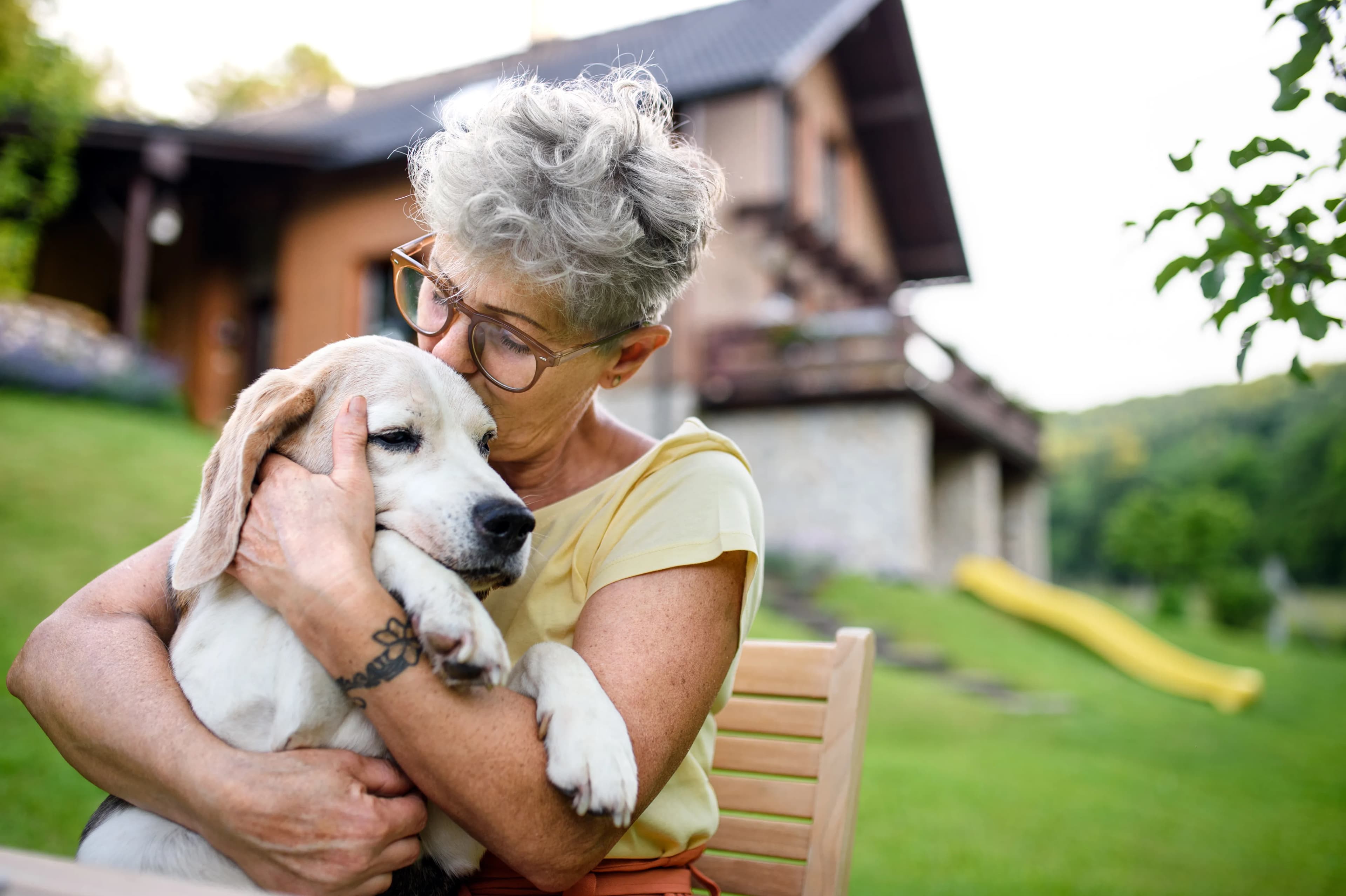 A woman sharing a tender moment with her dog outdoors