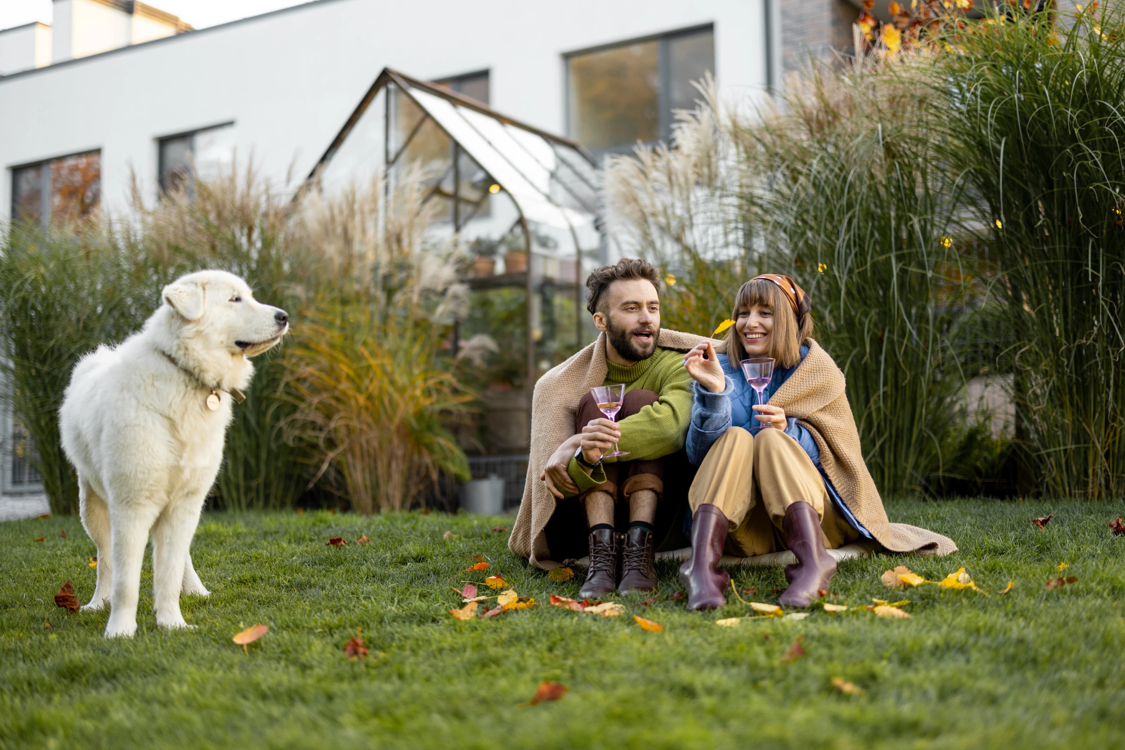 Couple relaxing outdoors with their dog in a leafy Burnaby setting